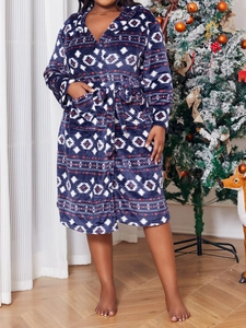 Detail of hooded plush bathrobe with ethnic print and drawstring waist in cozy room