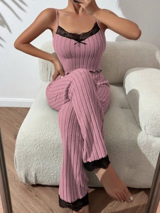 Detailed view of pink ribbed pajama set with black lace trim and bow knot detail