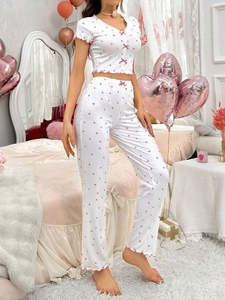 Detail showing pink heart prints and delicate ruffle trim on the white ribbed fabric