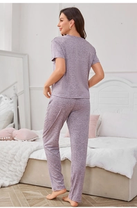 Detailed back view of a soft heathered purple knit pajama set in a bedroom setting