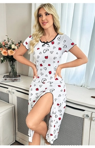 Dettaglio di pigiama bianco con stampe di cuori, fiocco nero e spacco laterale alto