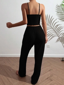 Detail view of women's black ribbed knit pajama set with camisole and high waist pants