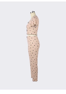 Detail of pink heart-print loungewear set featuring ribbed knit fabric and ruffled edges