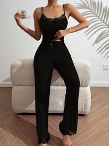 Detail of black ribbed loungewear set with lace trim on the camisole top and wide-leg pants