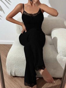Close-up of black ribbed lounge set featuring delicate eyelash lace trim and bow detail
