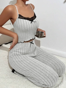 Detail of grey ribbed pajama set with black lace trim and bow on camisole and pants