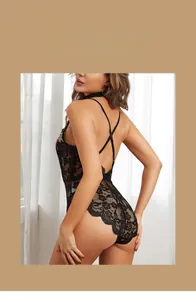 Detail of black lace sleepwear showing cross back straps and red floral embroidery