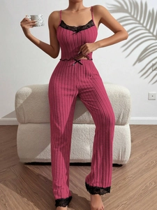 Detail of dark pink ribbed loungewear set with black lace trim and bow decorations