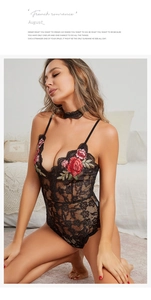 Detailed close-up of black lace bodysuit featuring red rose floral embroidery and choker