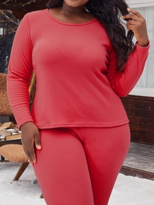 Détail d'un pyjama thermique rouge en polaire douce pour femme dans un décor d'hiver
