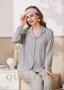 Detail of grey ribbed pajama set with pink contrast piping and embroidered pocket heart