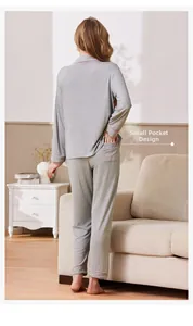 Detail view of the back pocket with pink love embroidery on gray ribbed pajama pants