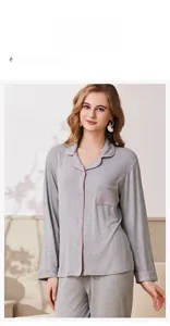 Detail of grey ribbed pajama set featuring pink trim and Love embroidery on the pocket