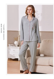 Detail of grey pajama set showing pink piping on lapel pocket and ribbed fabric texture