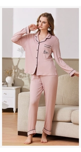 Detail of pink ribbed pajama set with black contrast piping and love embroidery