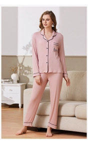 Detail of light pink ribbed pajama set featuring long sleeves and a button-down shirt
