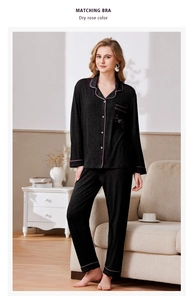 Detail of black women's long-sleeve pajama set with dry rose pink contrast piping