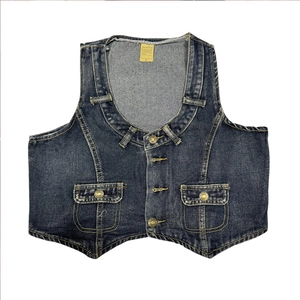 Detail of vintage washed denim vest featuring metal buttons and front flap pockets