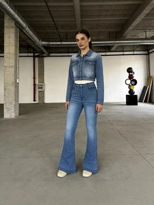 Women's vintage washed blue denim set with cropped jacket and high-waisted flared jeans