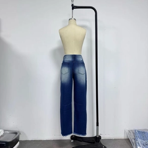 Detail of high-waisted blue wide-leg jeans with vintage washed back pockets and raw hems
