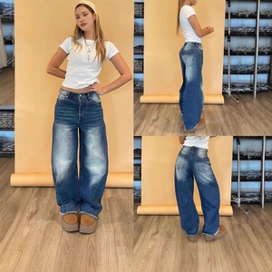Three-way view of high-waisted wide-leg jeans with vintage wash and frayed hem details