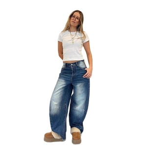 Full view of loose high-waist wide-leg jeans with vintage washed blue denim texture