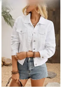 Close-up of a white denim jacket with classic collar, metal buttons and chest pockets