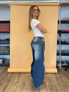 Relaxed fit high-waist wide-leg jeans in dark blue wash, shown from a side-back view