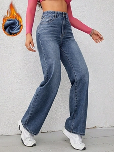 Detail of high-waisted wide-leg jeans in washed blue with warm fleece thermal lining