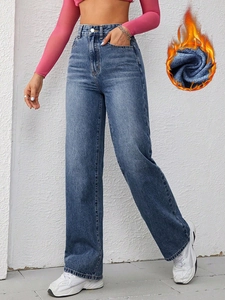 Detail showing plush thermal lining and high-waisted fit of straight leg blue jeans