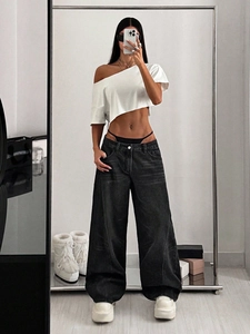 Street style outfit featuring a white off-shoulder crop top and black wide-leg cargo jeans