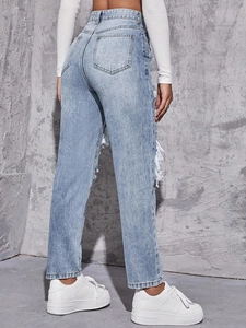 Detailed back side view of high waist distressed straight jeans with large ripped holes