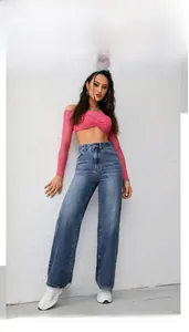 Detailed outdoor shot of high-waisted wide-leg denim jeans in a medium blue washed finish
