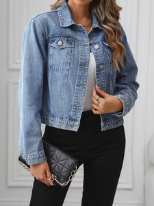 Detail of short light blue denim jacket featuring classic lapels and front flap pockets