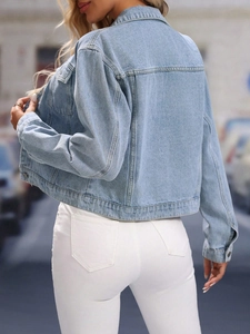 Rear view of a light blue cropped denim jacket with classic collar and stitching details