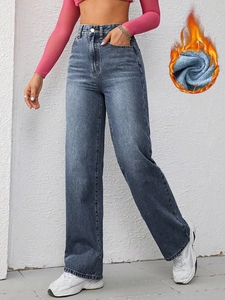 Detail of high-waist wide-leg jeans showing the warm fleece lining and deep blue denim
