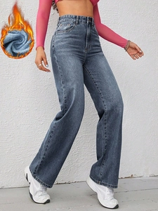 Detail of high-waisted wide-leg jeans with warm fleece lining and vintage blue finish