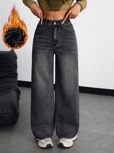 Detail of high-waisted grey denim jeans showing the warm thermal fleece lining inside