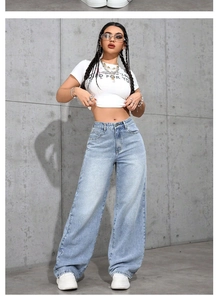 Close-up of high-waisted light blue wide-leg jeans with washed denim texture and loose fit