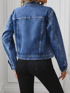 Back view of a classic indigo denim jacket showing tailored seams and premium wash detail