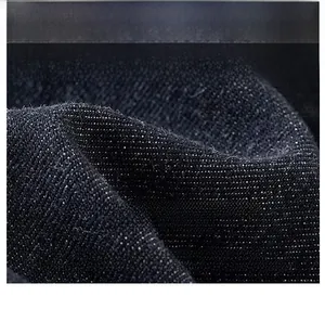 Macro shot of premium washed denim fabric showing twill texture and tight fiber weaving
