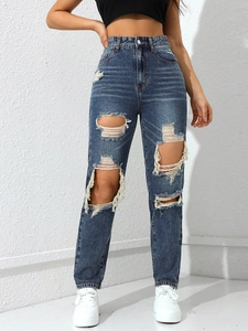 Close-up of high waist straight jeans featuring heavy distressed and ripped knee details