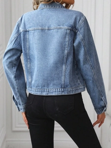 Rear view of classic blue washed denim jacket with loose fit and shoulder drop tailoring