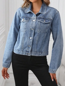 Close-up of a light blue denim jacket featuring classic lapels and silver metal buttons