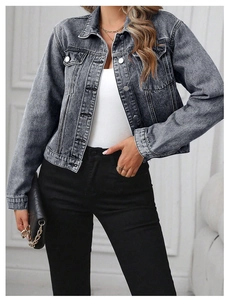 Detail of grey acid wash denim jacket with metal buttons and classic chest pockets