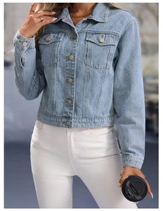 Detail shot of light blue denim jacket featuring metal buttons and flap pockets