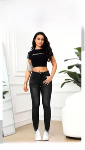 Détail d'un jean slim noir à taille haute avec texture délavée vintage pour femmes