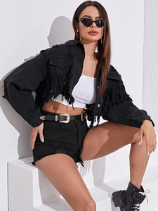 Detail view of black cropped denim jacket with heavy distressed fringe and tassel hem