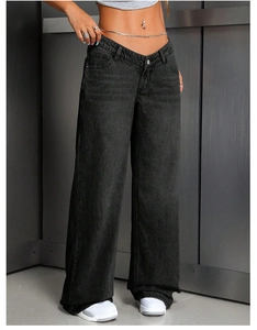 Detail of high waisted wide leg jeans with unique V-shaped cross waist design in washed black