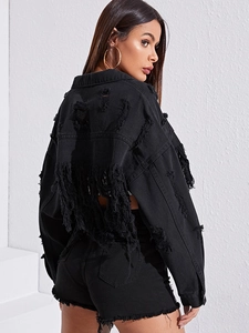 Detail of ripped tassel texture and heavy distressing on black denim jacket back